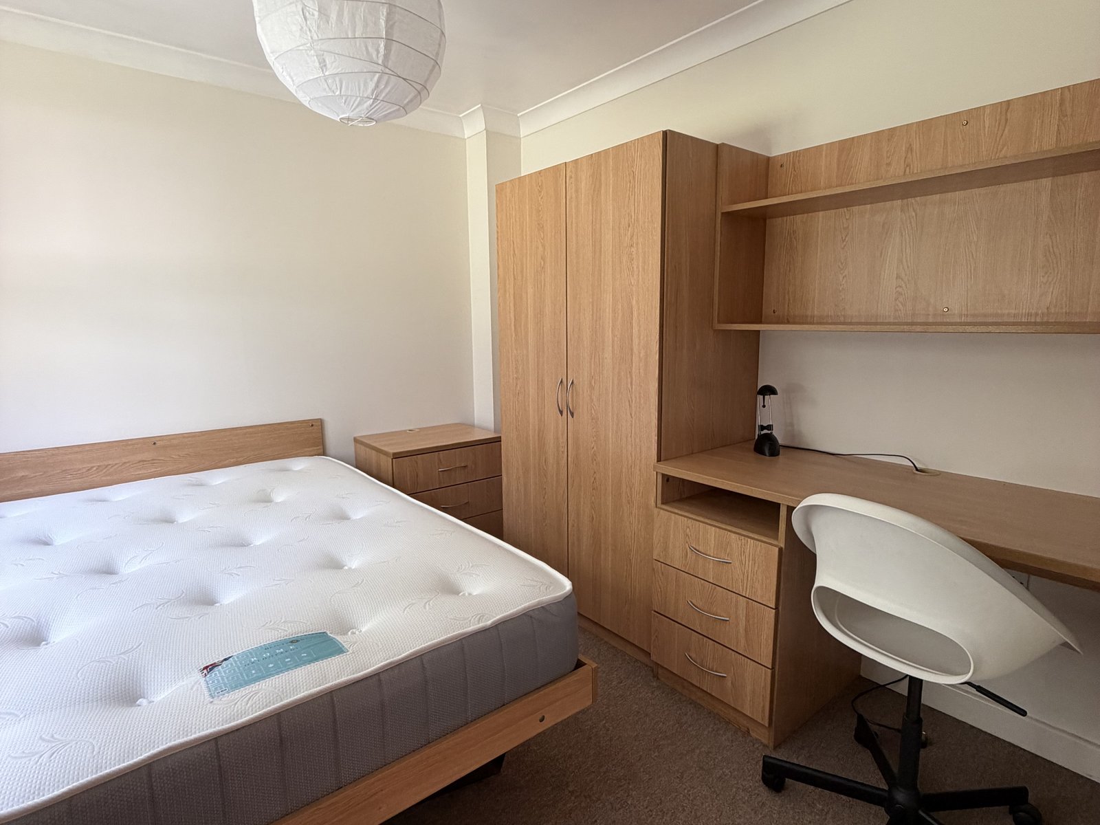 Double bedroom with integral desk in a one bedroom apartment at Conel Court